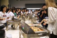 College students enjoying a palatable buffet dinner at the opening ceremony of CWC Festival